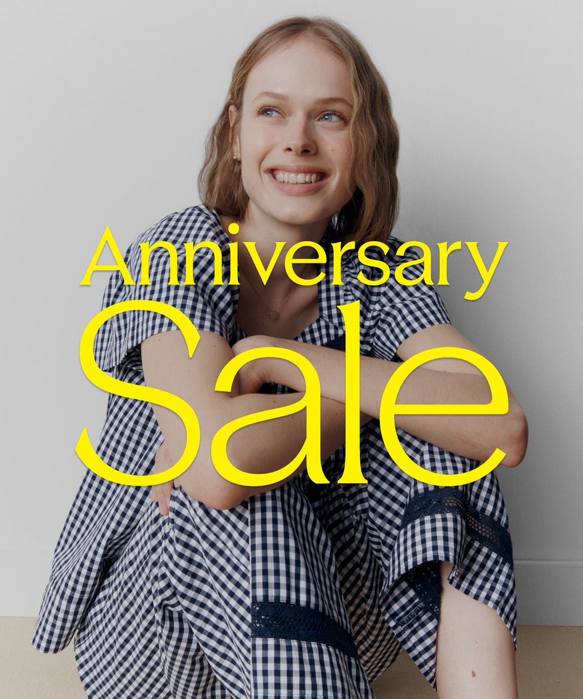 Anniversary Sale: a woman in a blue and white gingham PJ set.