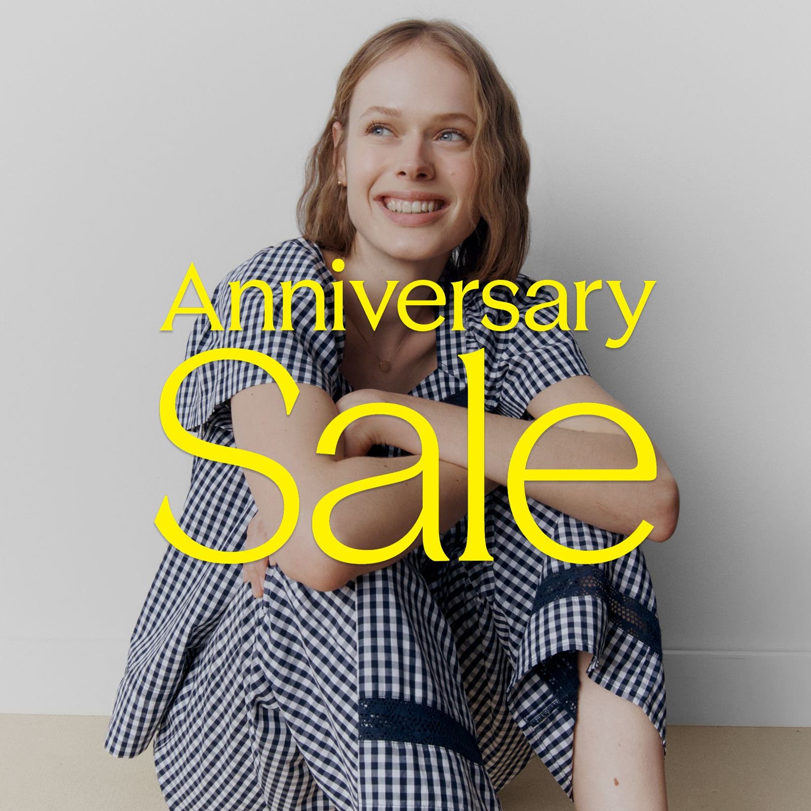 Anniversary Sale: a woman in a blue and white gingham PJ set.