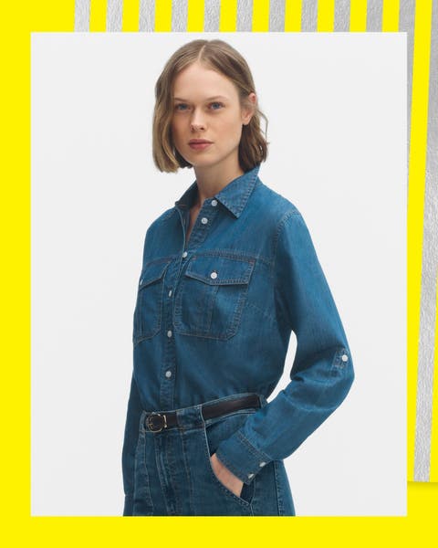 A woman wearing a denim button up shirt.