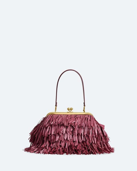 Rose-colored raffia top-handle bag.