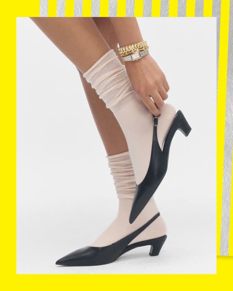 A woman wearing socks with heels.
