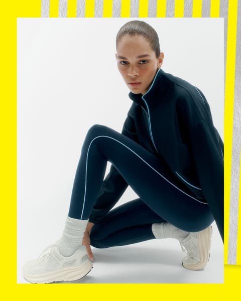 A woman wearing sneakers and a track suit.