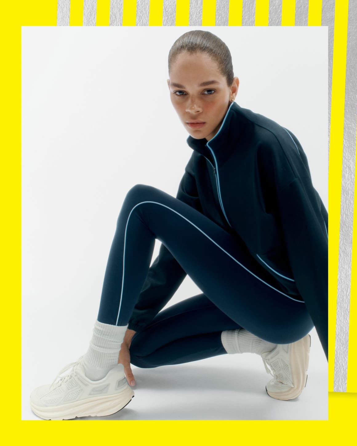 A woman wearing sneakers and a track suit.