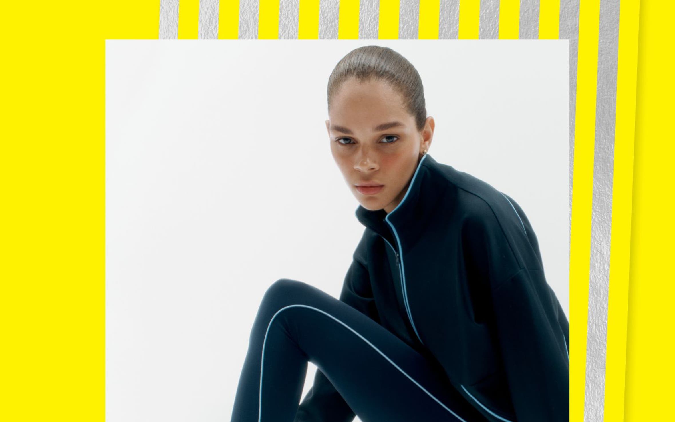 A woman wearing sneakers and a track suit.