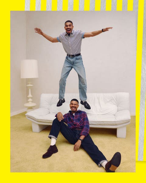 Two men wearing shirts and jeans.