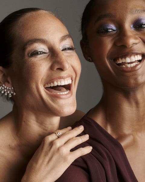 Two women wearing sparkling eyeshadow.
