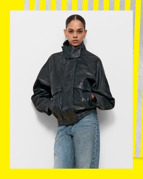 A woman in ripped jeans and a black leather bomber jacket.