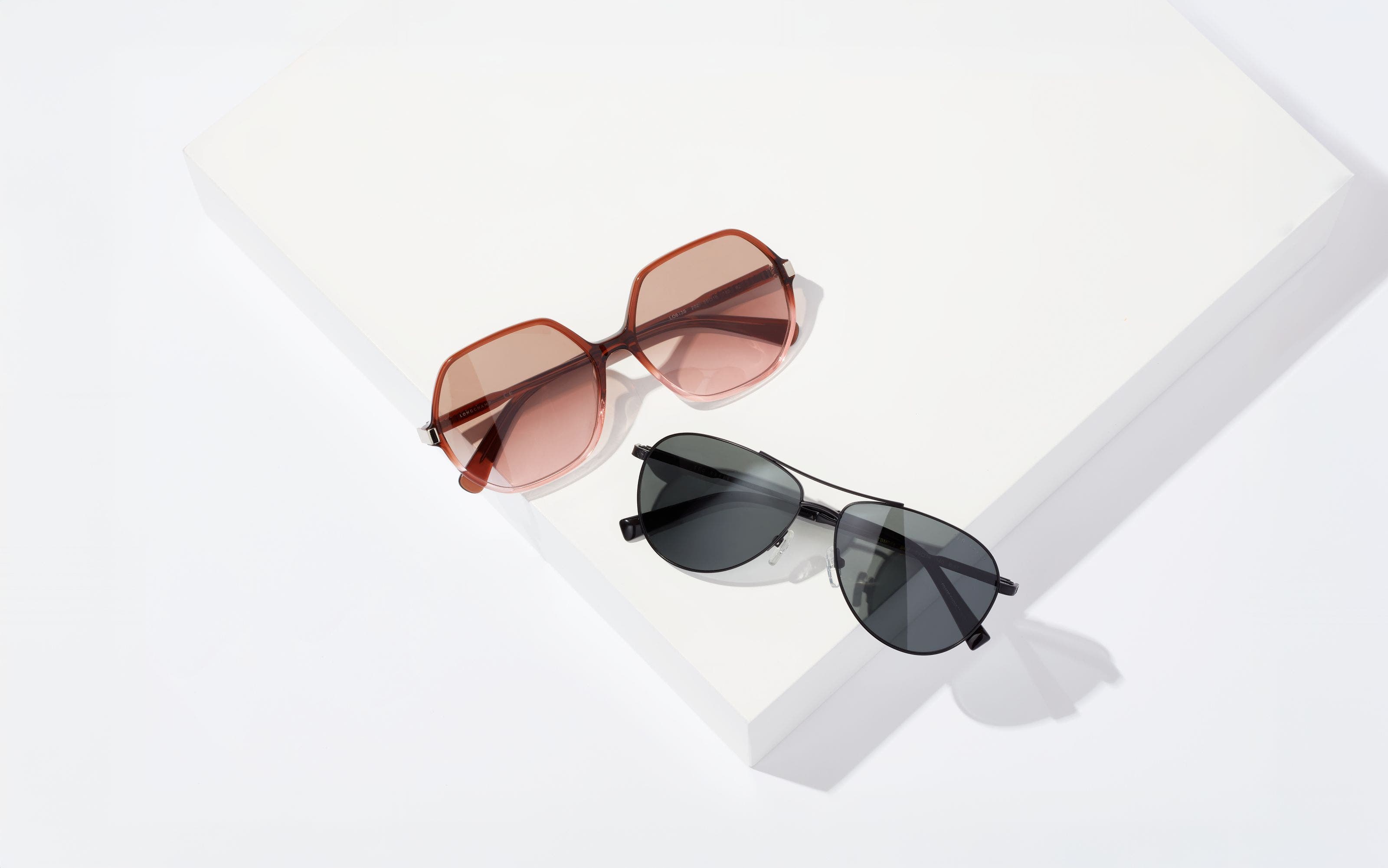 Rose-colored sunglasses and black sunglasses.