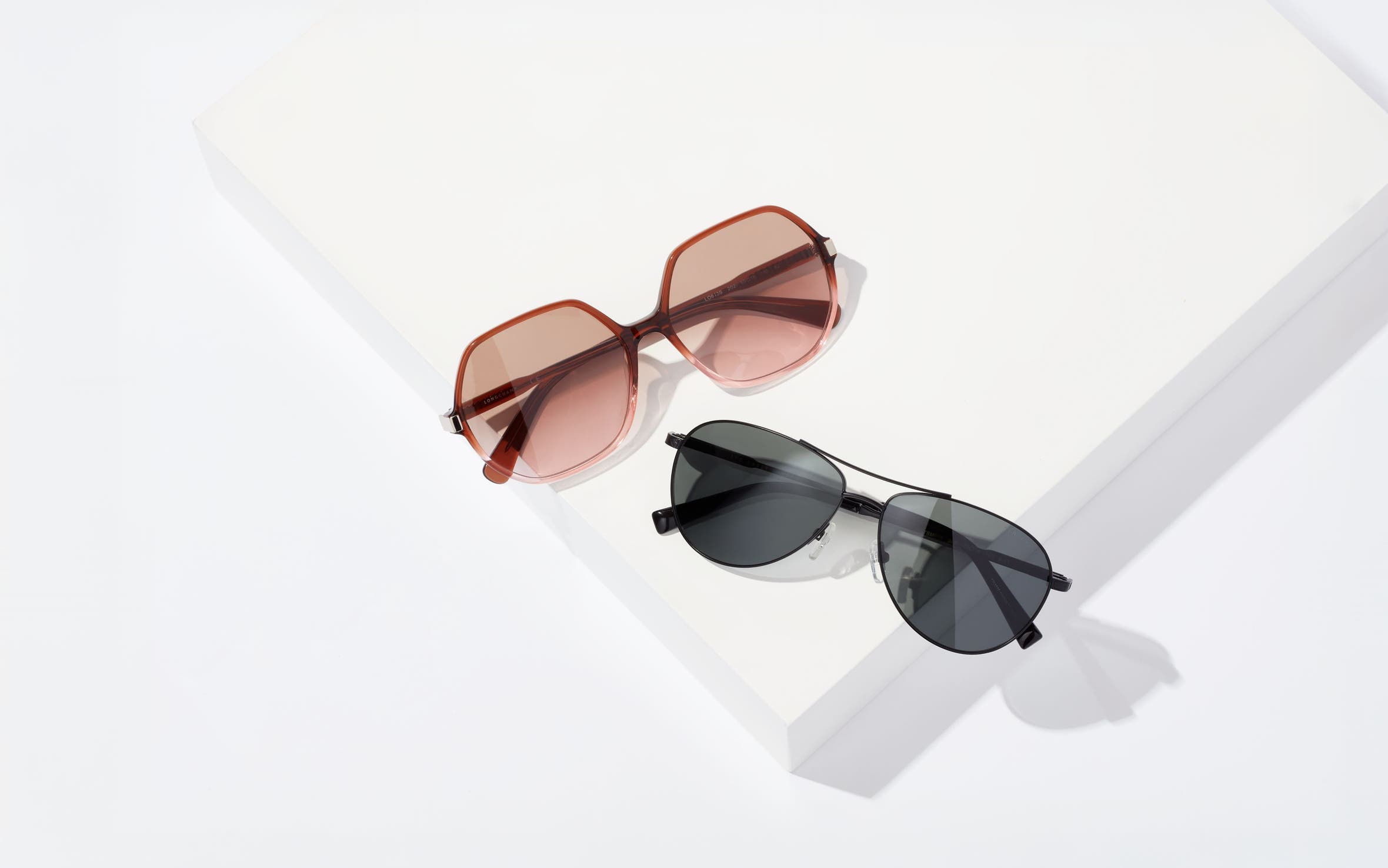Rose-colored sunglasses and black sunglasses.