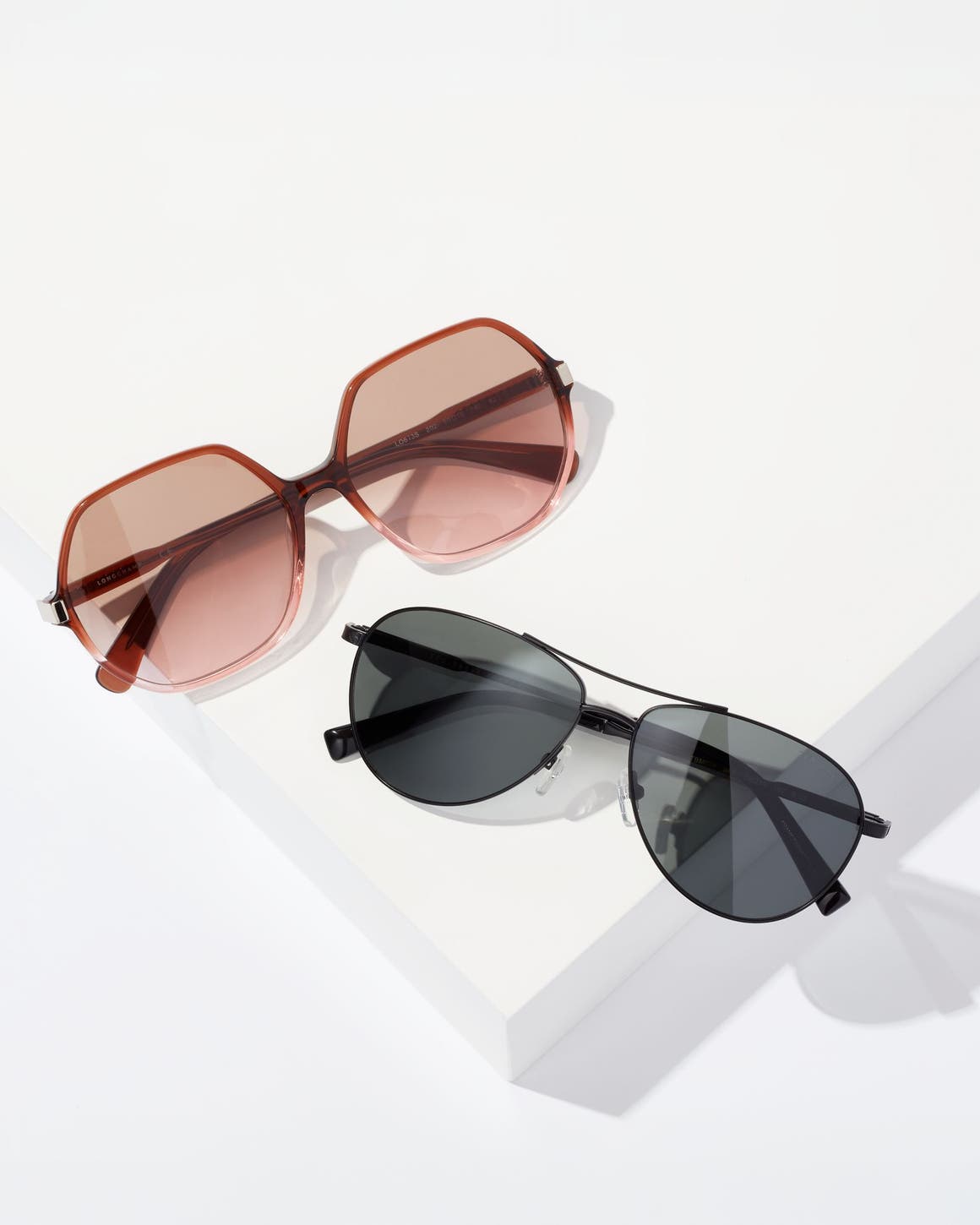Rose-colored sunglasses and black sunglasses.