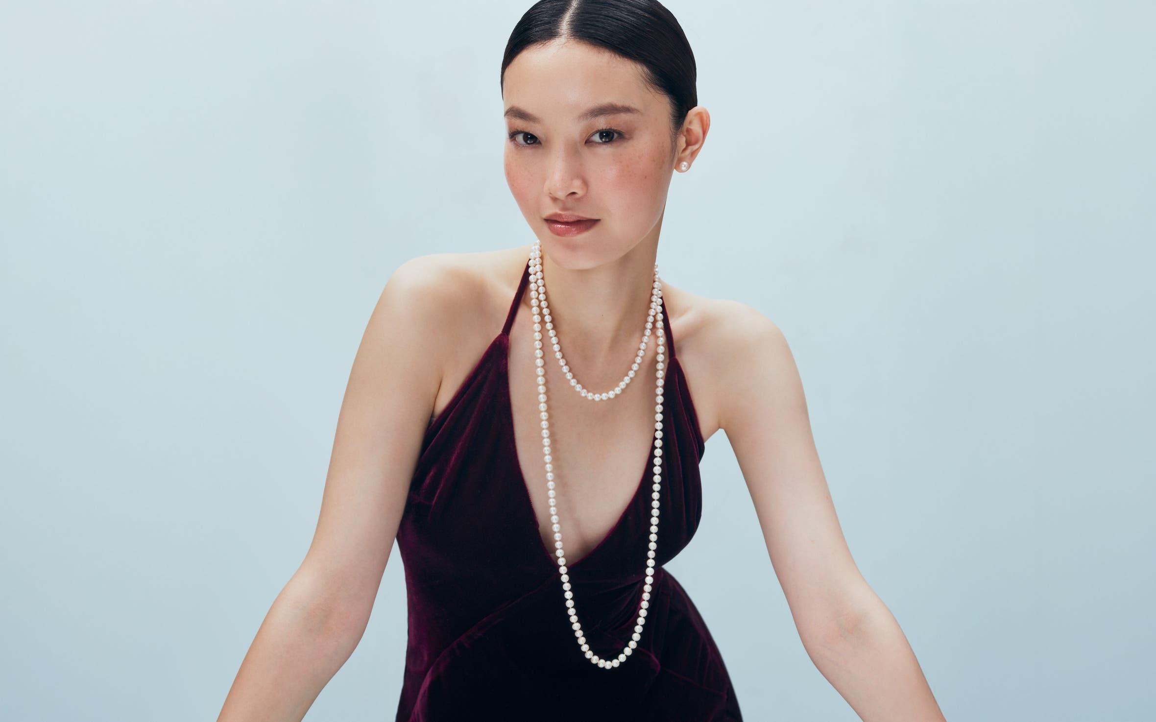 A woman wearing a pearl necklace.