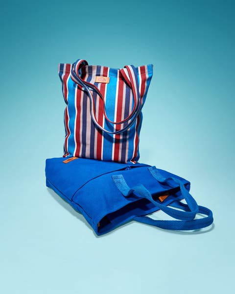 Two tote bags — a red, white, and blue striped canvas tote and a solid cobalt blue tote.