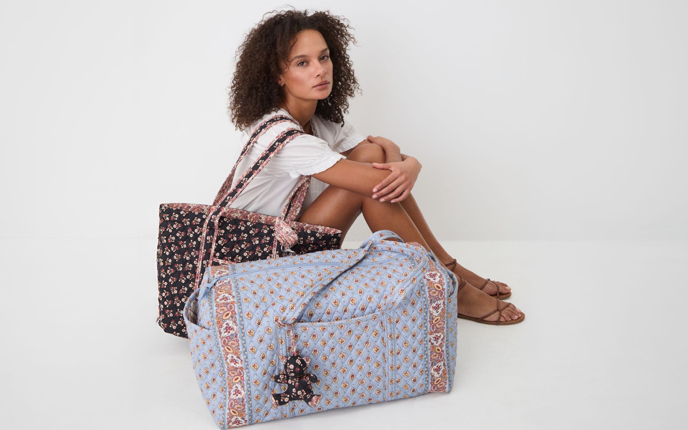 A woman with paisley quilted totes.