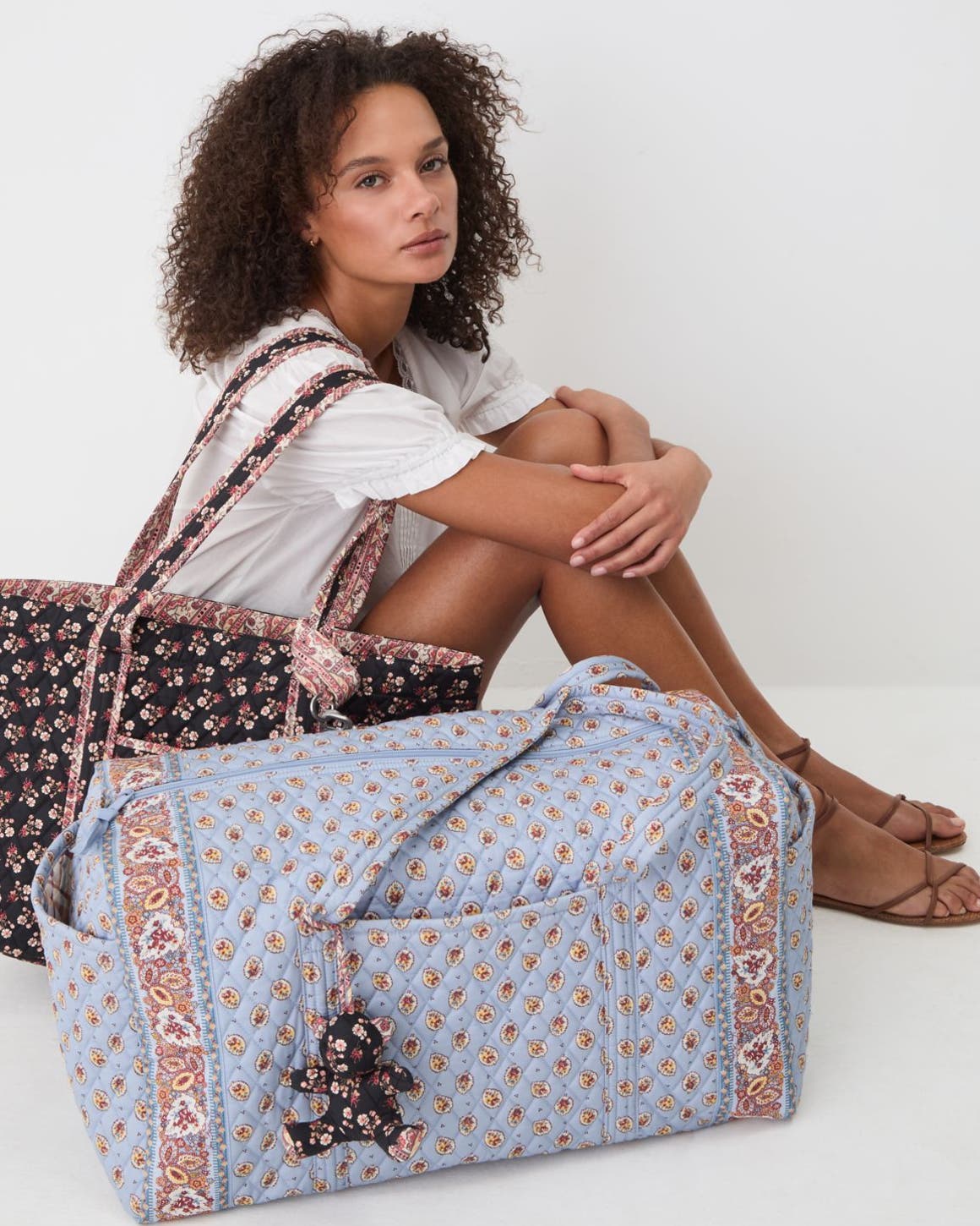 A woman with paisley quilted totes.
