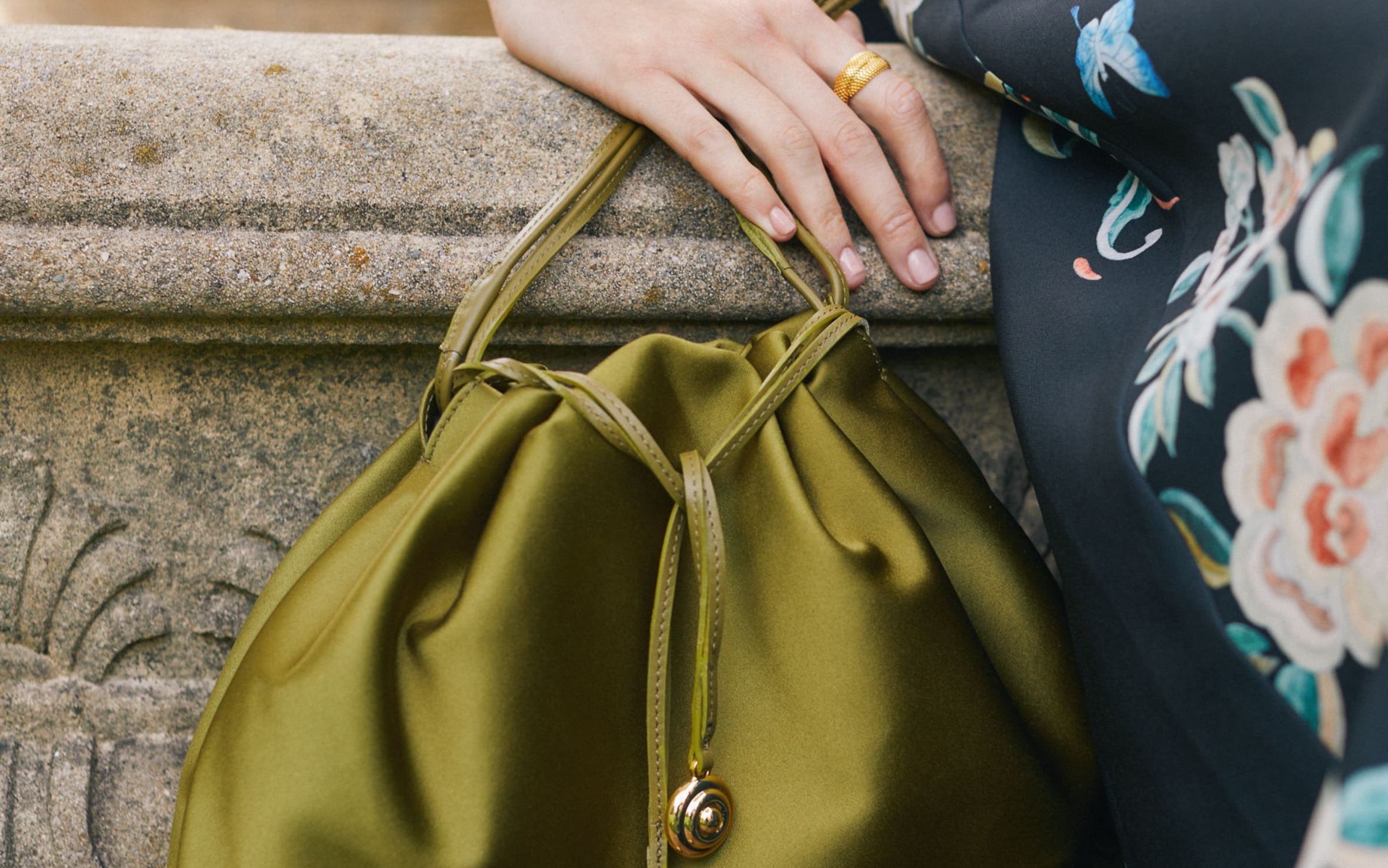 A woman holding a satin evening bag. 
