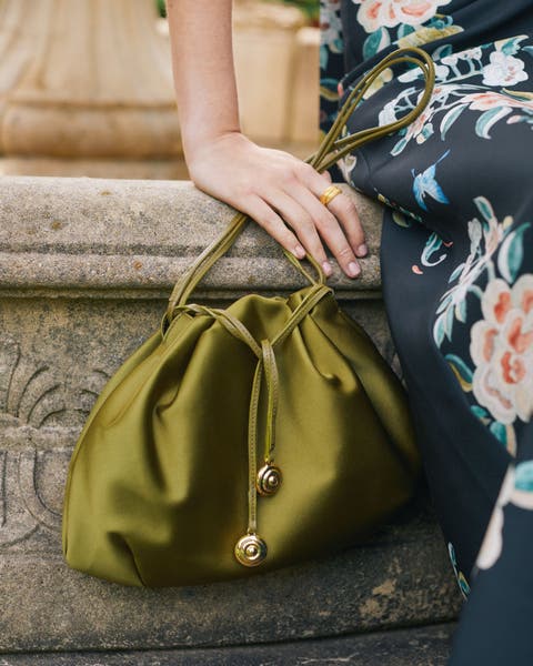 A woman carrying a satin evening bag. 