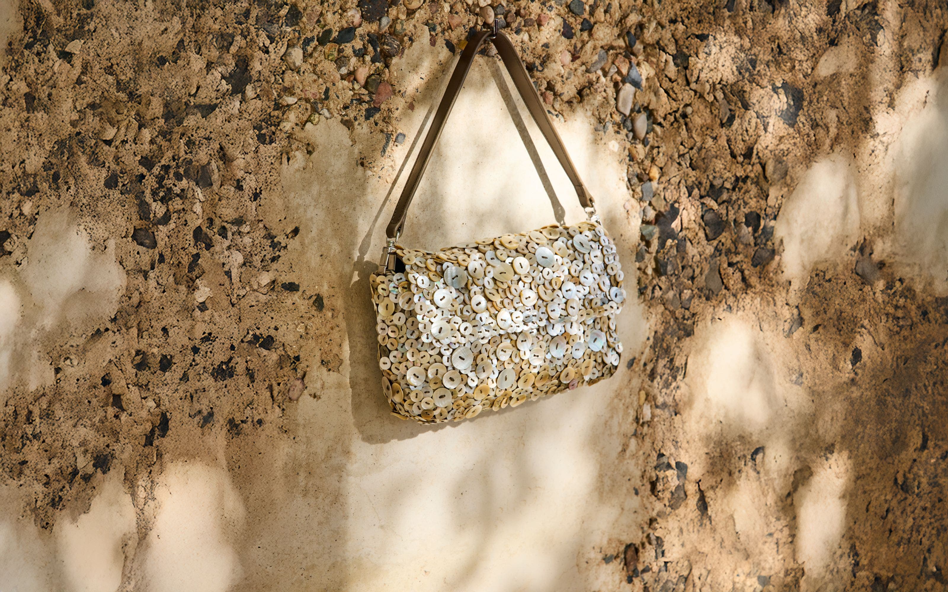 Handbag covered in mother-of-pearl buttons.