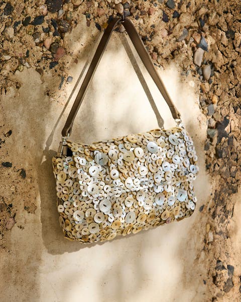 Handbag covered in mother-of-pearl buttons.