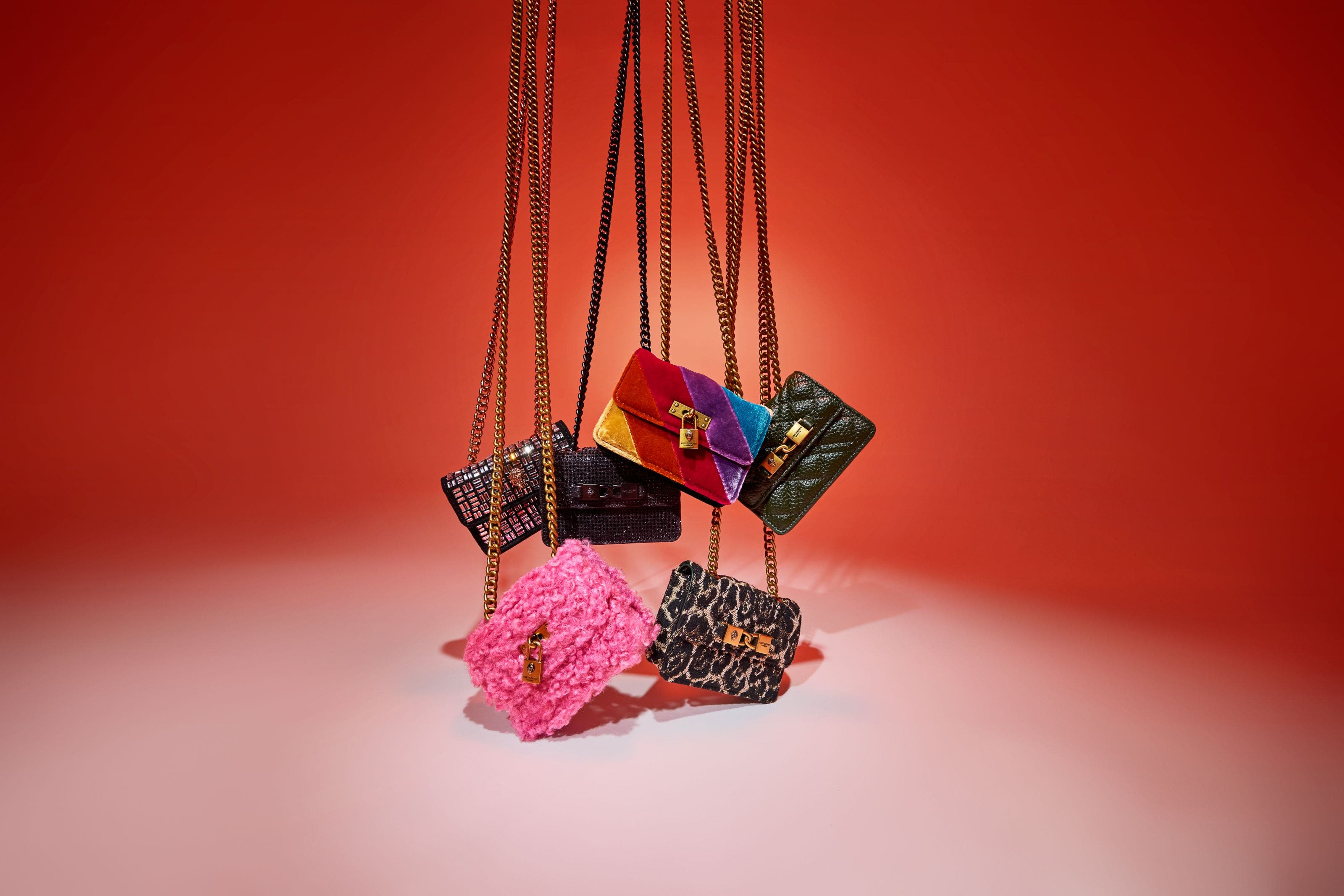 An assortment of handbags with chain-link straps.