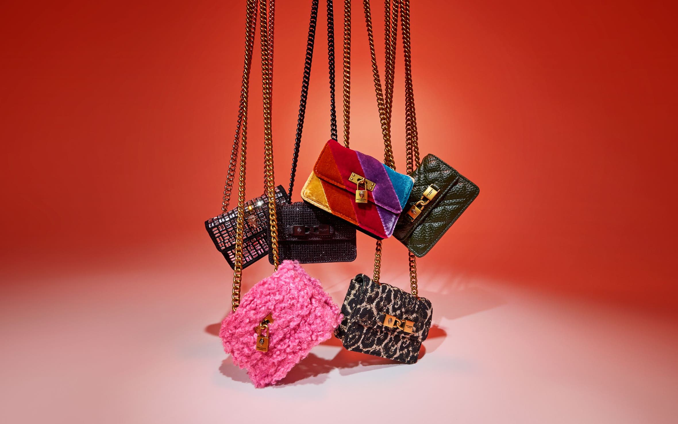 An assortment of handbags with chain-link straps.