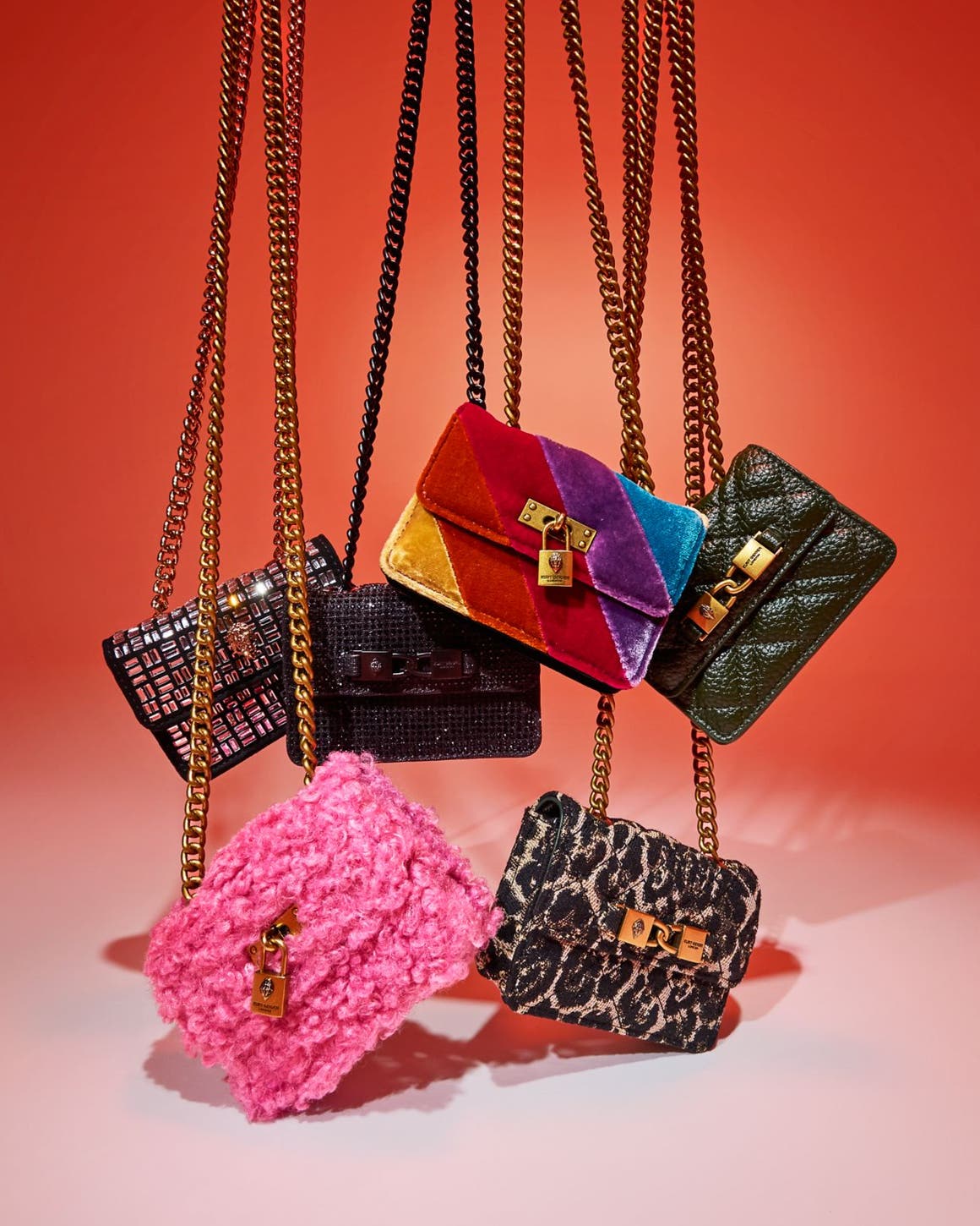 An assortment of handbags with chain-link straps.