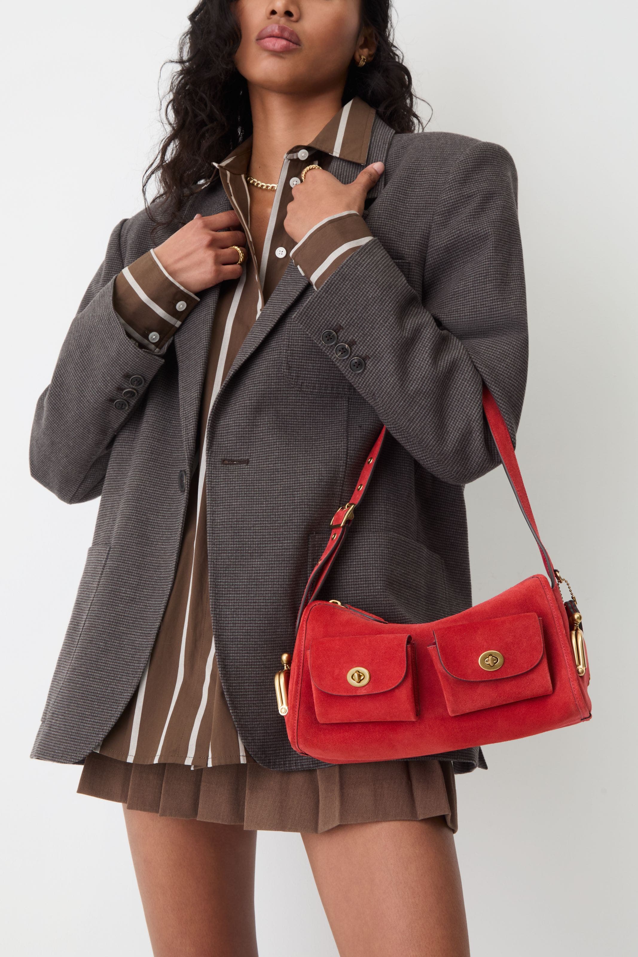 A woman carrying a red shoulder bag. 