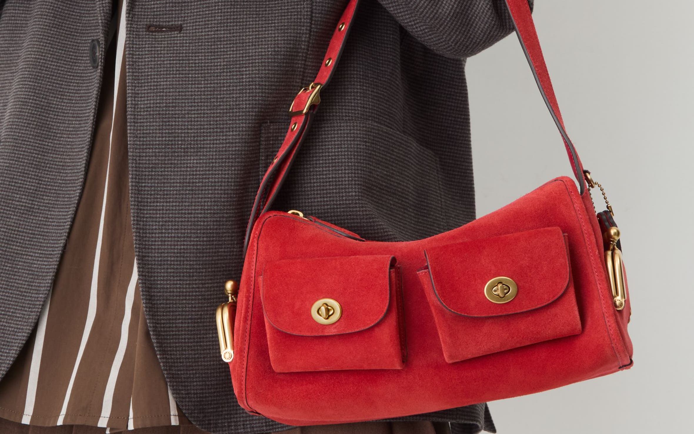A woman carrying a red shoulder bag.