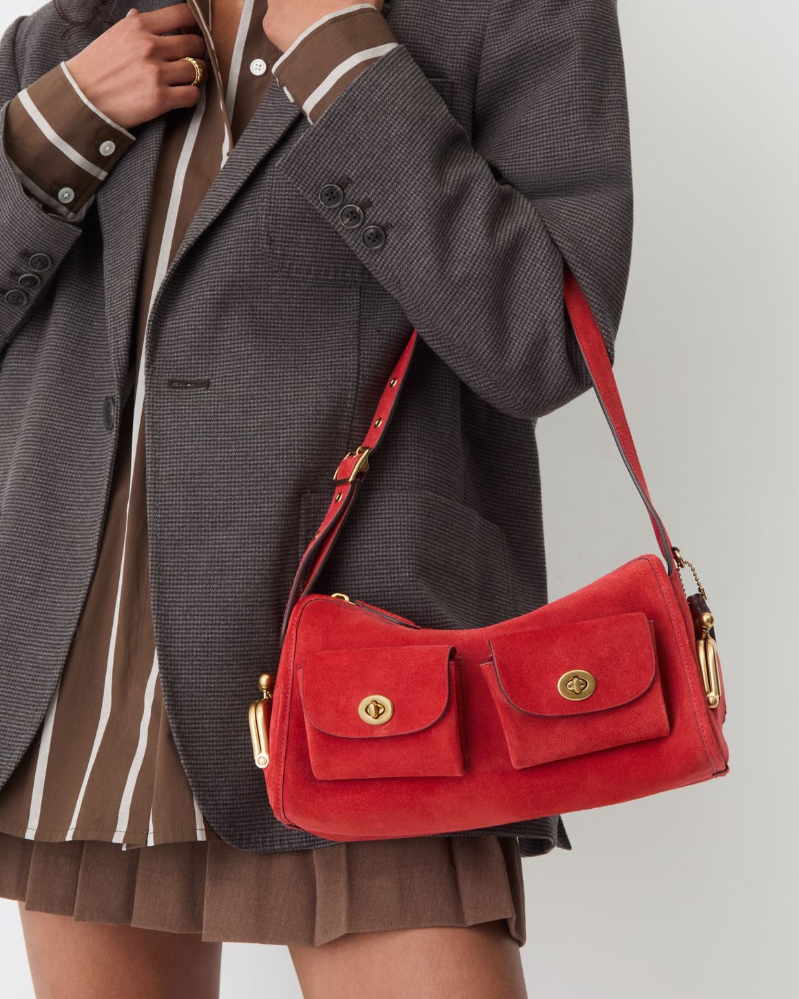 A woman carrying a red shoulder bag.
