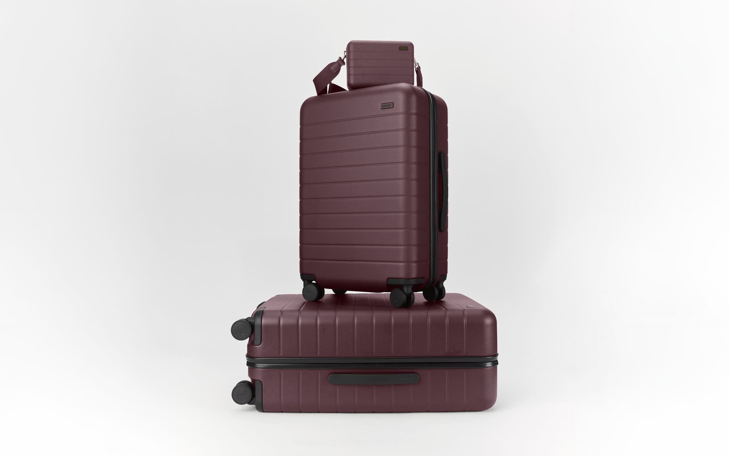 Wheeled luggage set in plum.
