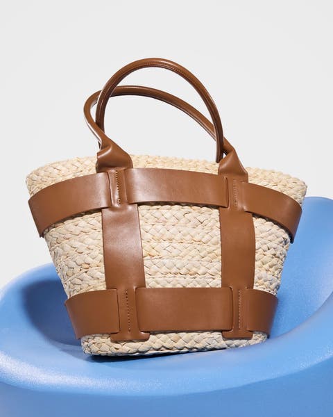 A woven straw tote with brown accents.