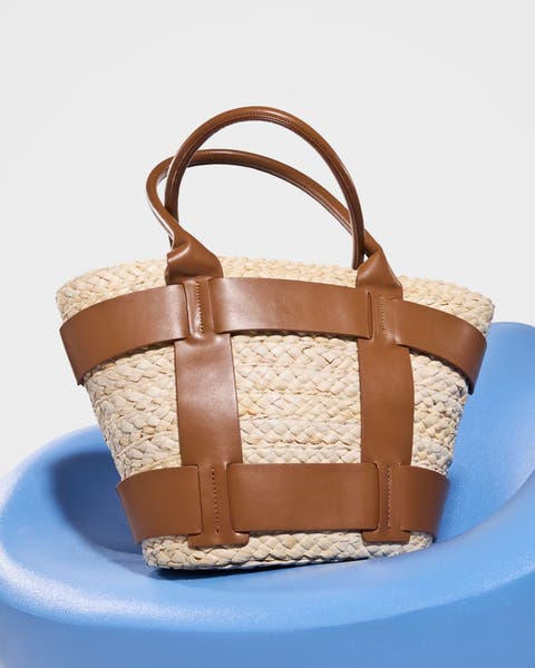 A woven straw tote with brown accents.