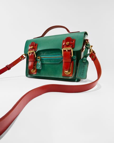 A green crossbody bag with red accents.