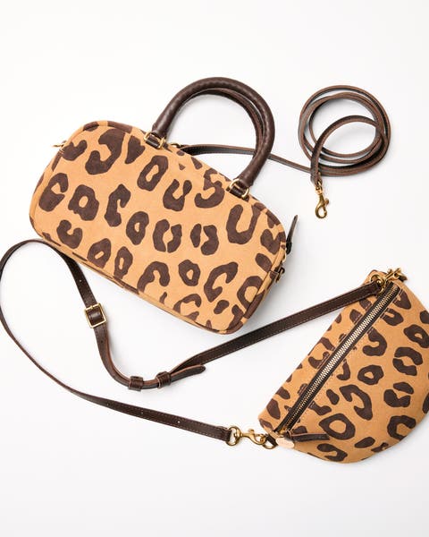 A pair of matching animal-print handbags. 