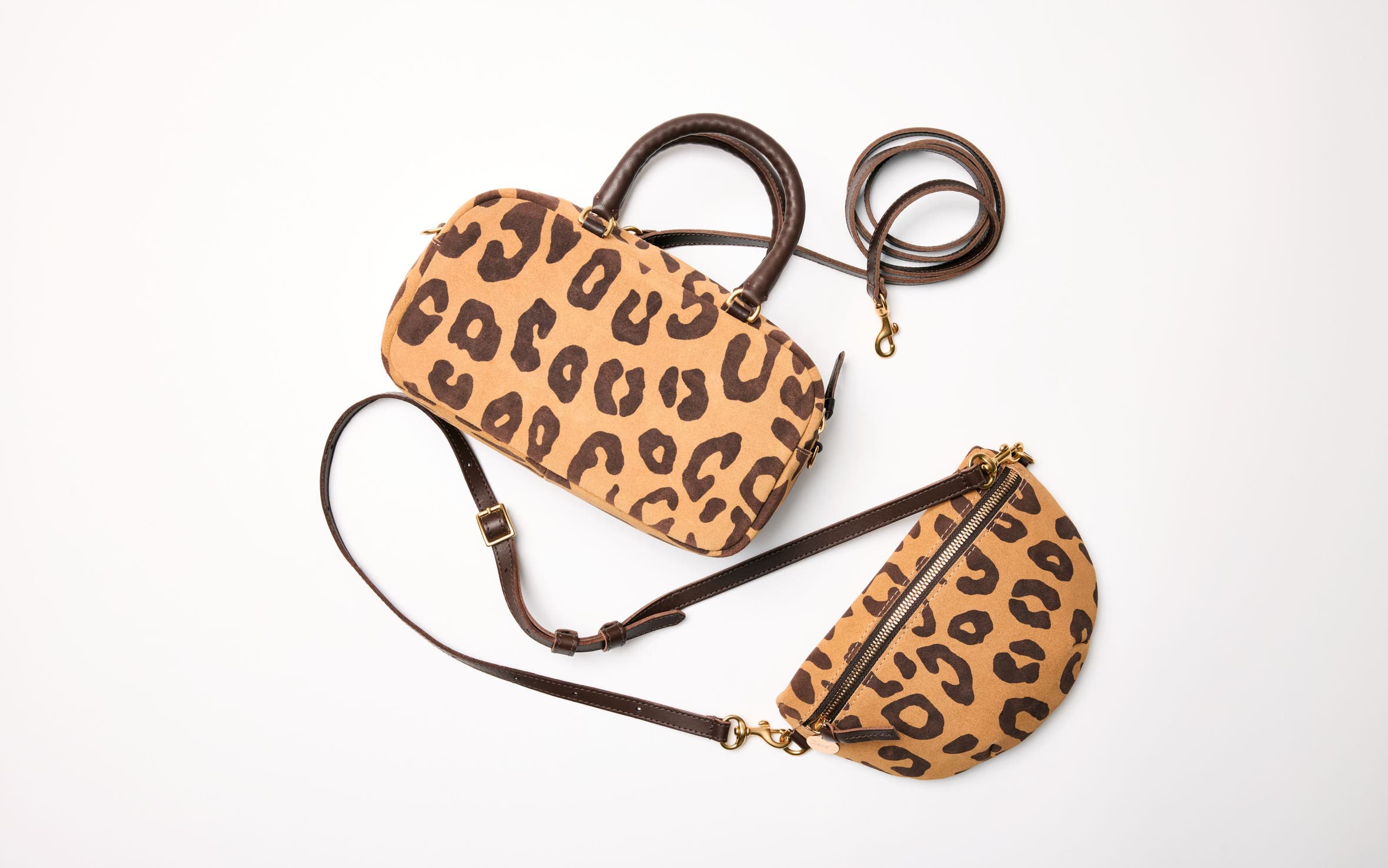A pair of matching animal-print handbags. 