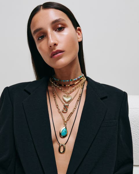 Woman wearing Open Edit necklaces.