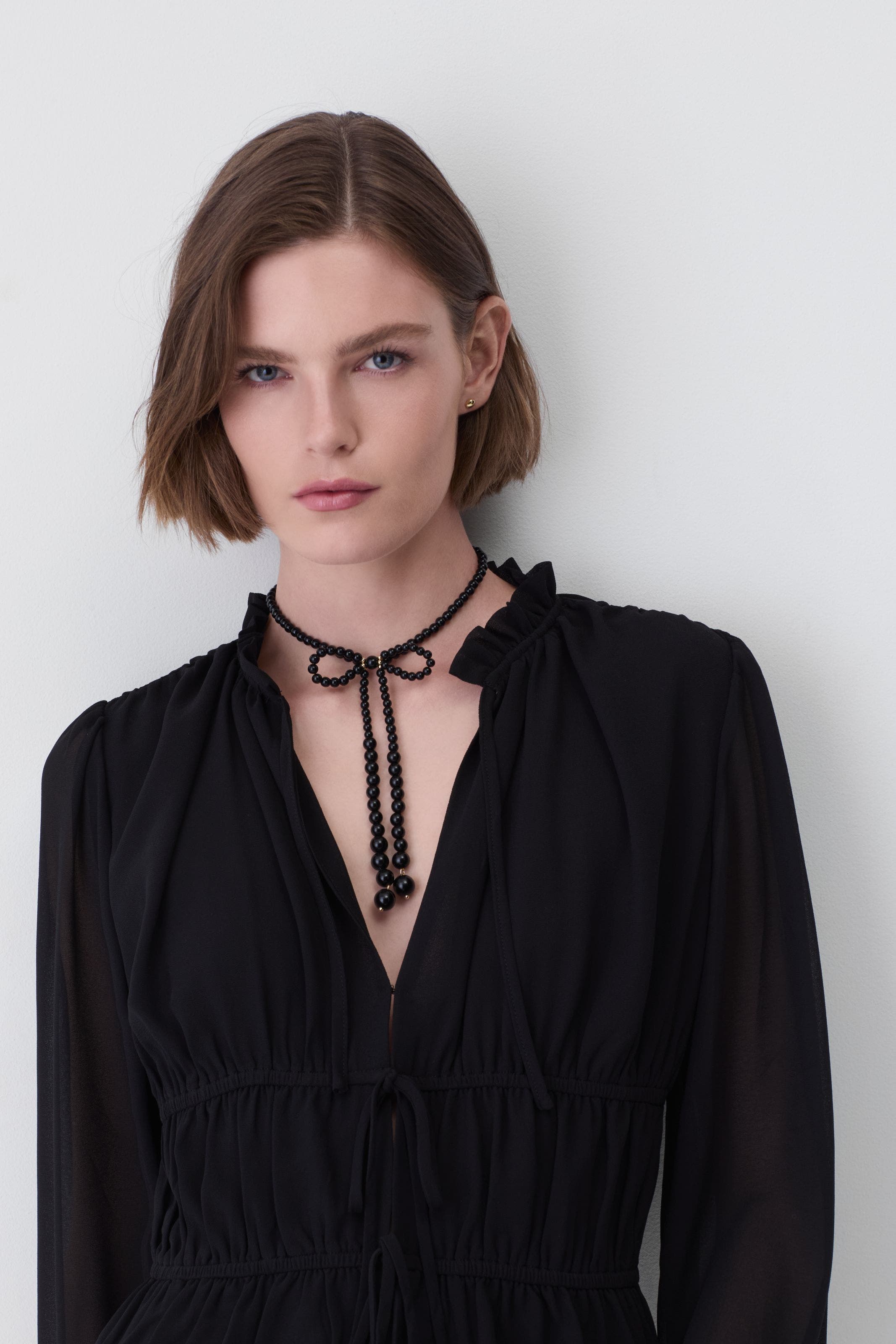 A woman wearing a black blouse.