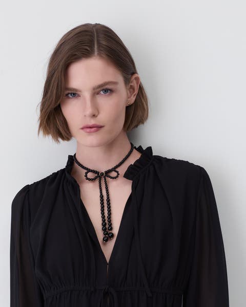 A woman wearing a black blouse.