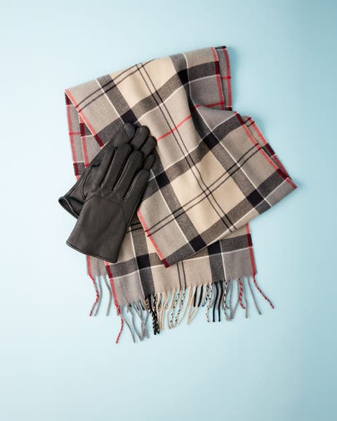 A plaid scarf and leather gloves.