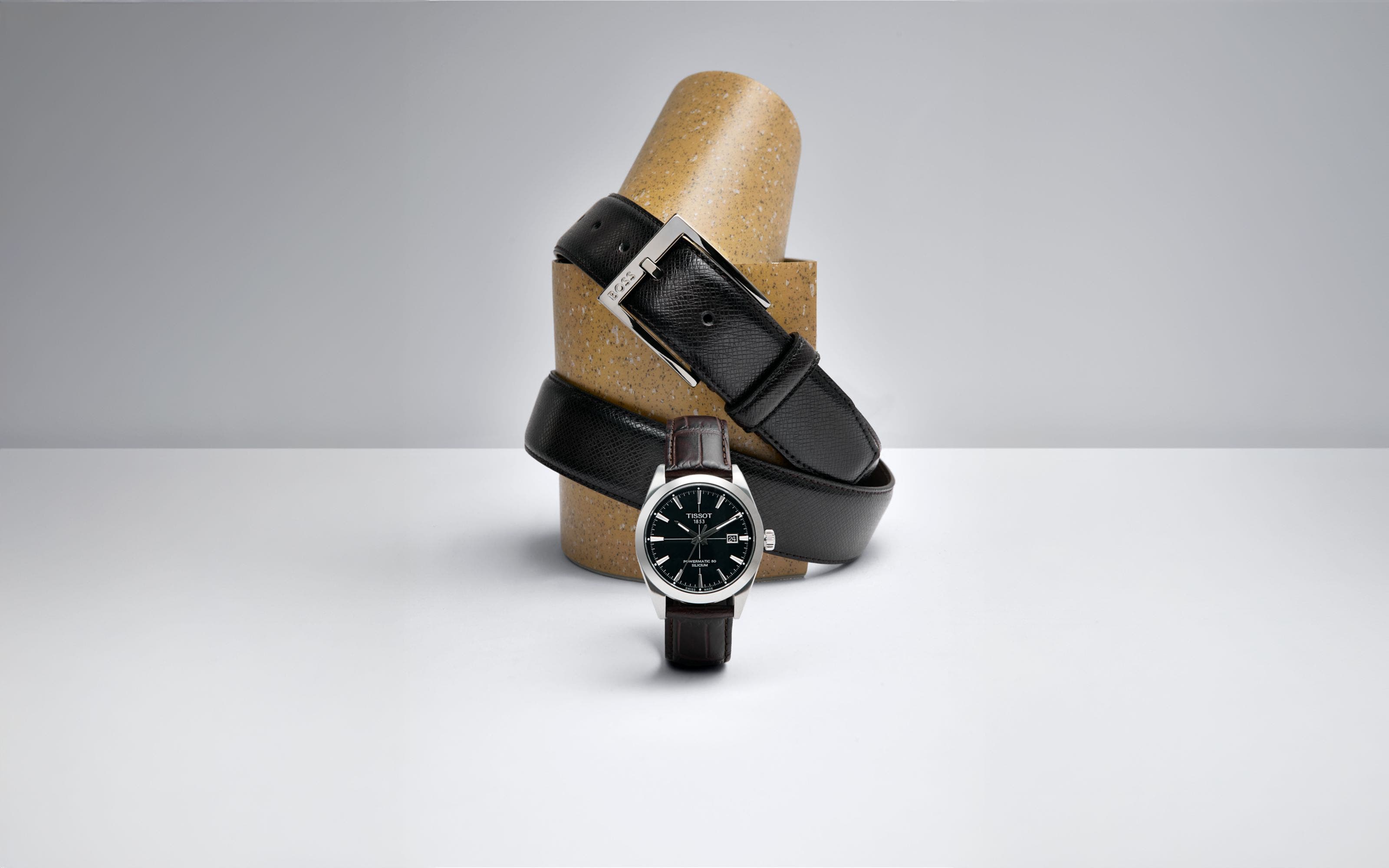 Three watches with black straps.