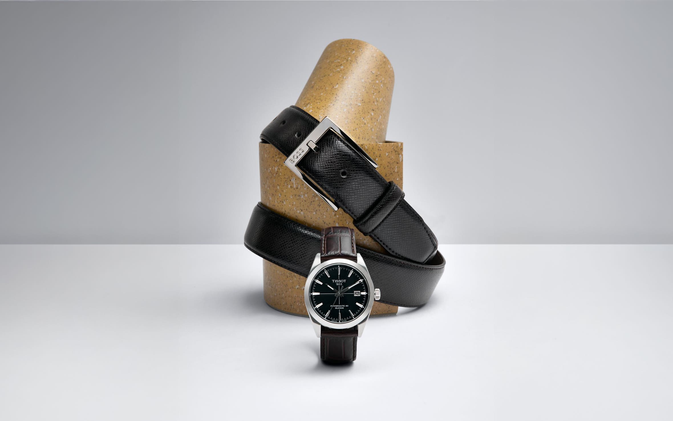 Three watches with black straps.