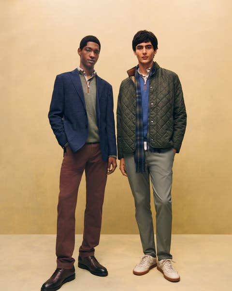 Two men in jackets, sweaters and jeans.