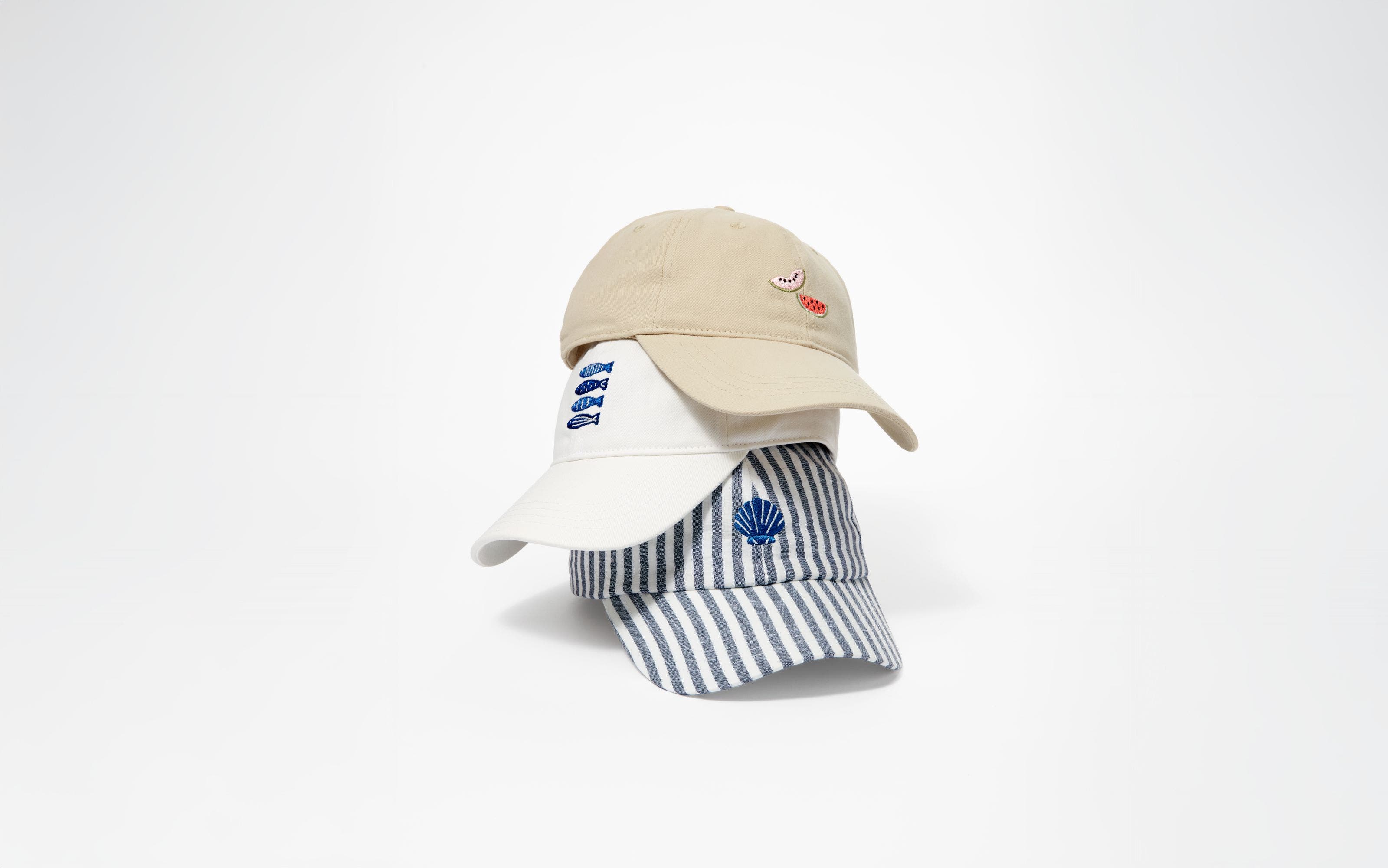 A stack of three baseball caps.