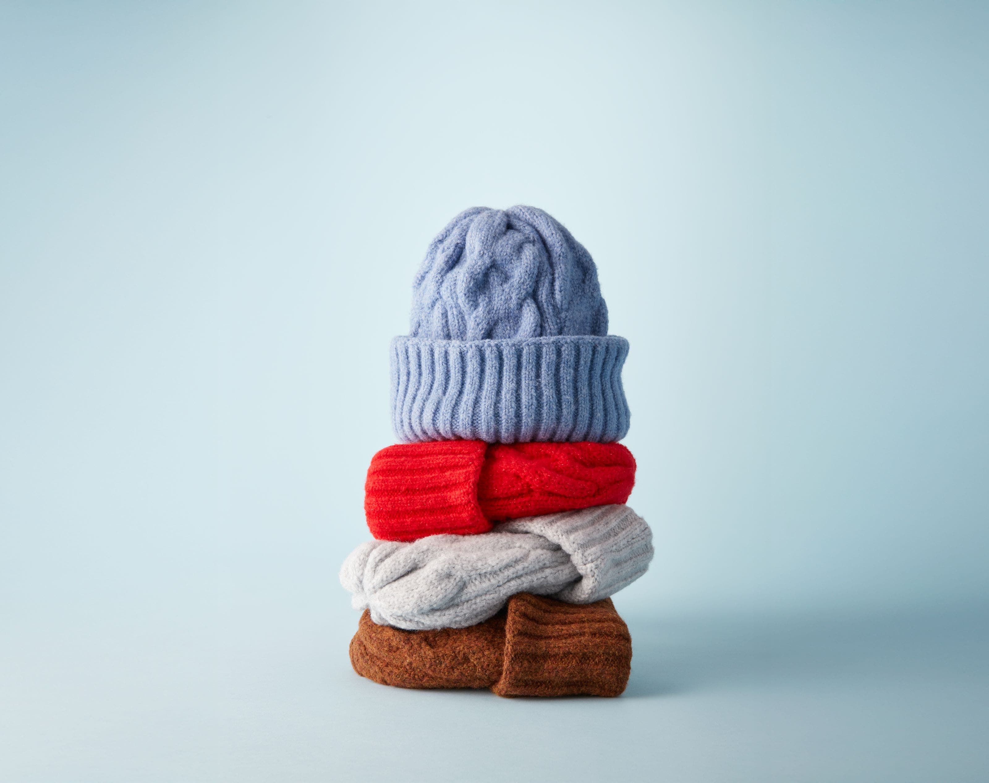 Knit hats in blue, red, grey and brown.