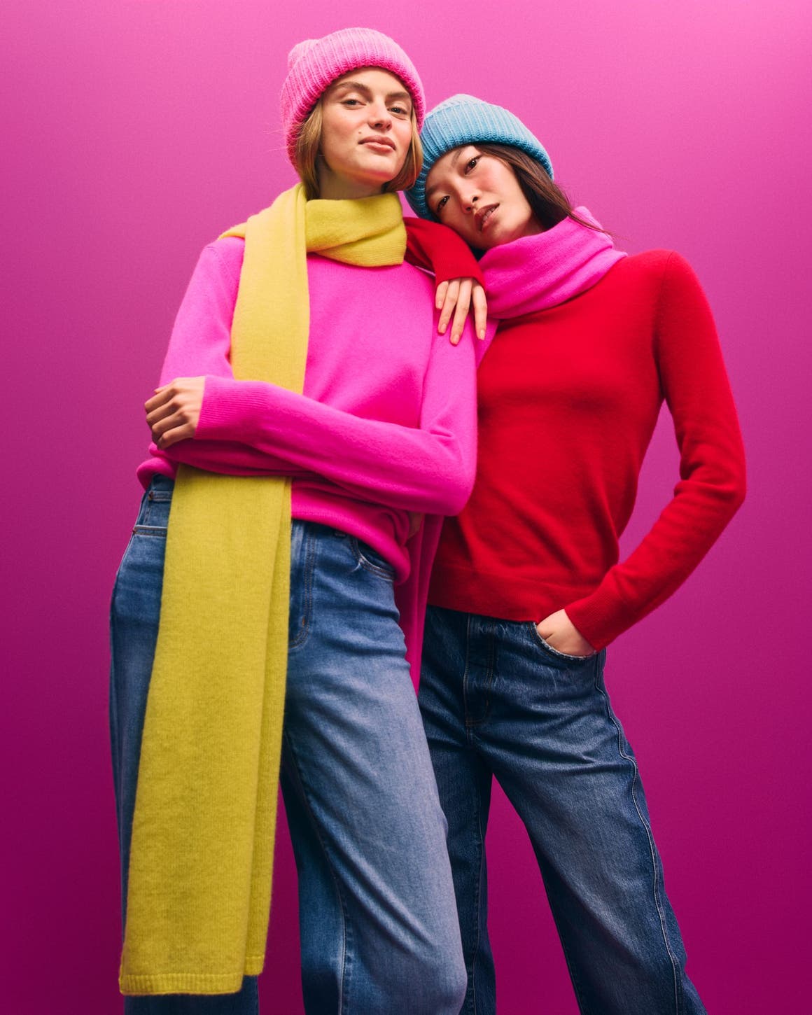 Two women in cashmere scarves and sweaters.