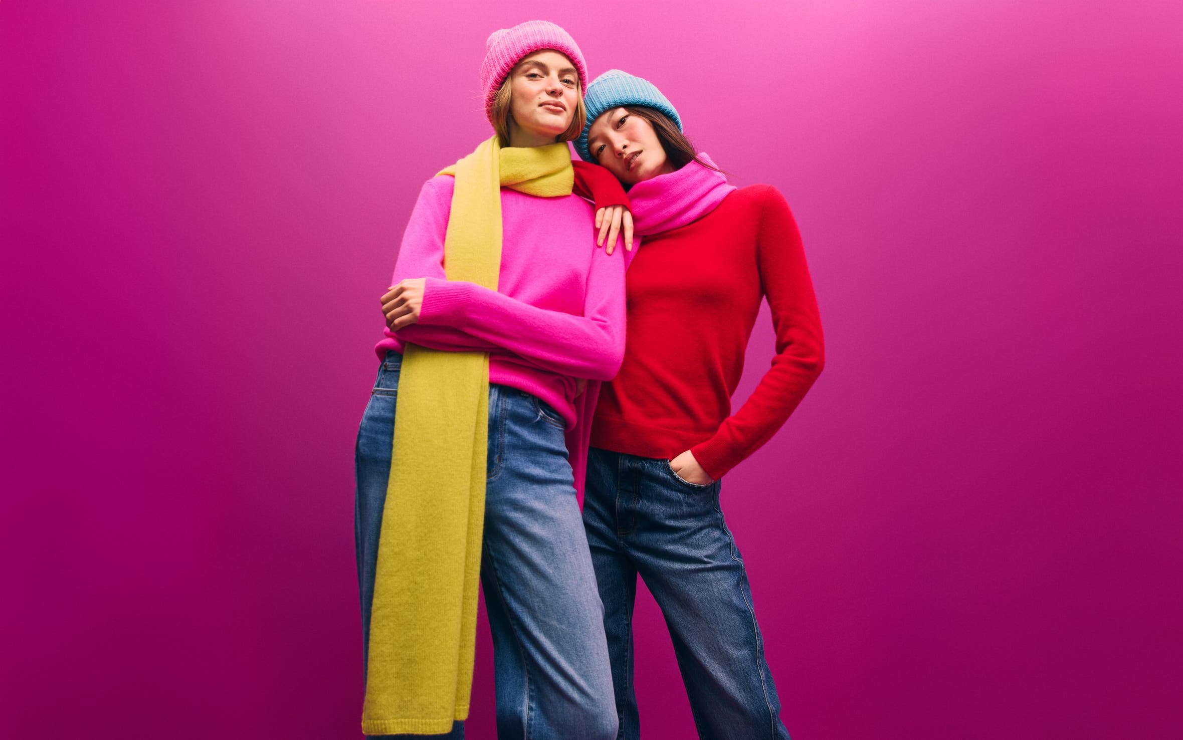 Two women in cashmere scarves and sweaters.