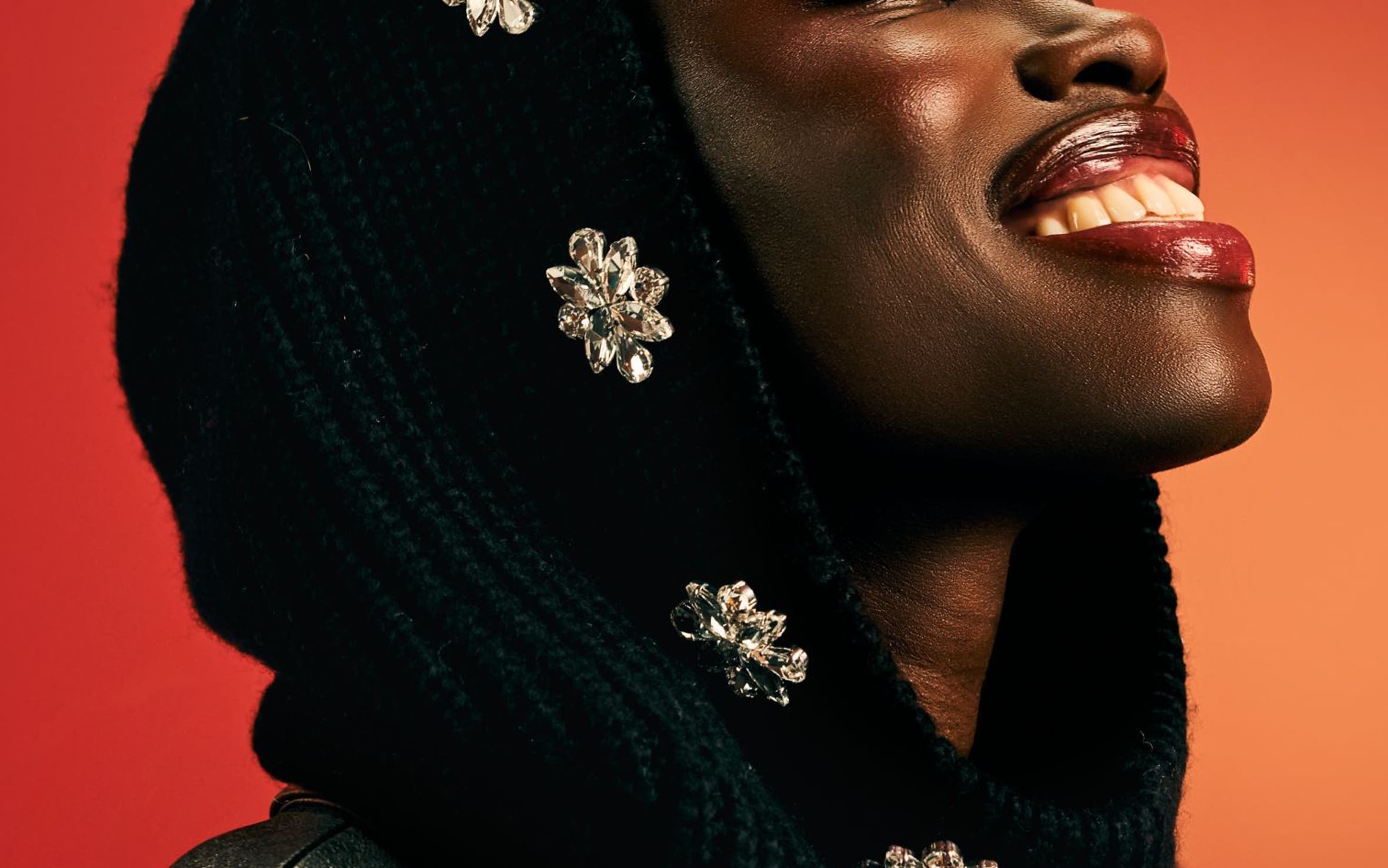 A woman wearing a black bejeweled scarf.