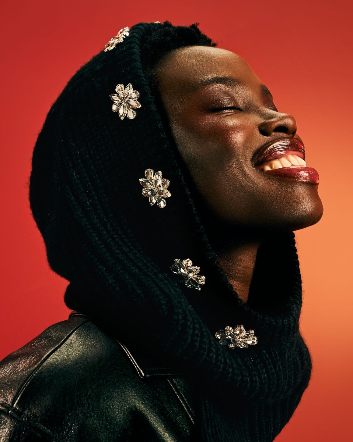 A woman wearing a black bejeweled scarf.