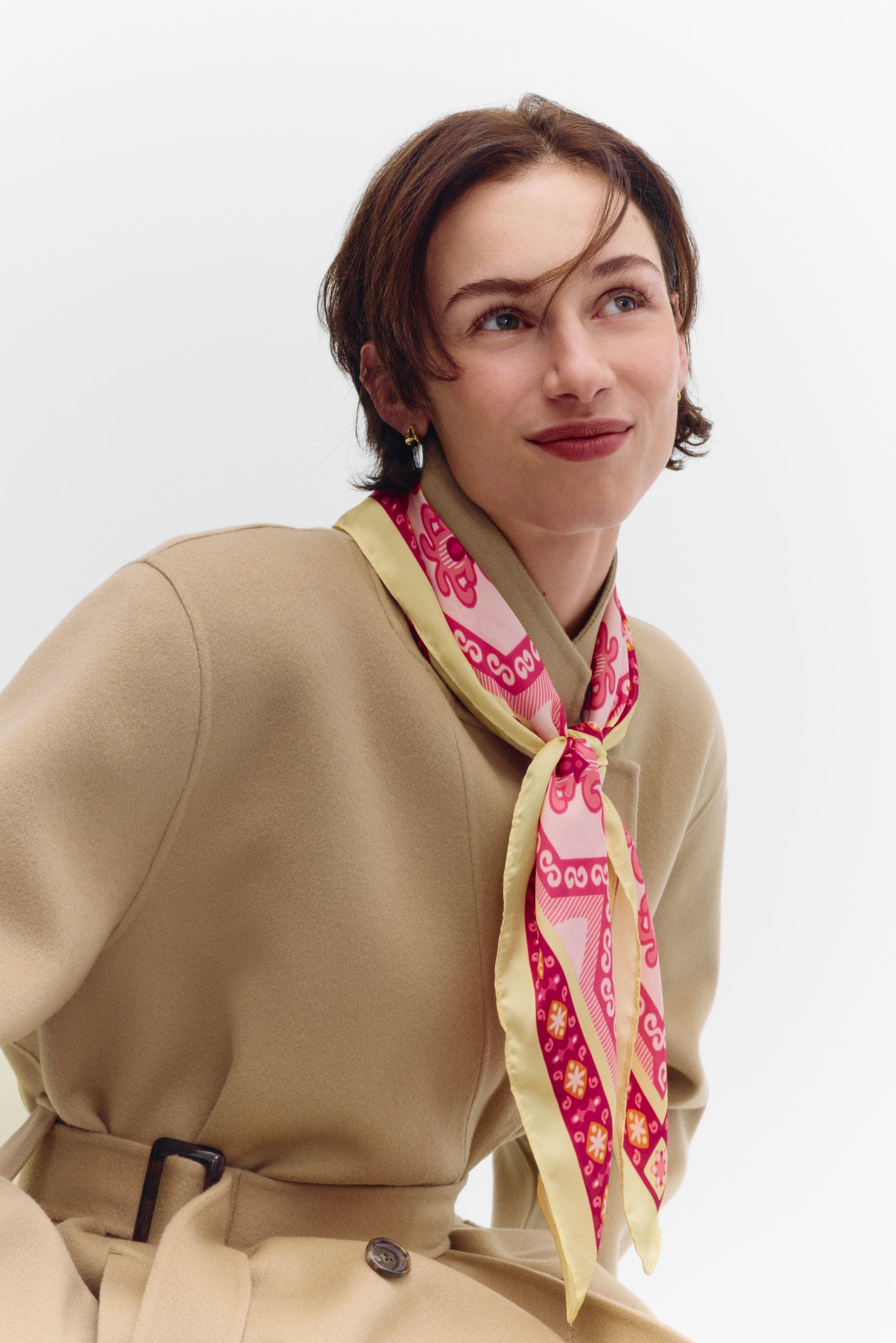 A woman wearing a pink neck scarf. 