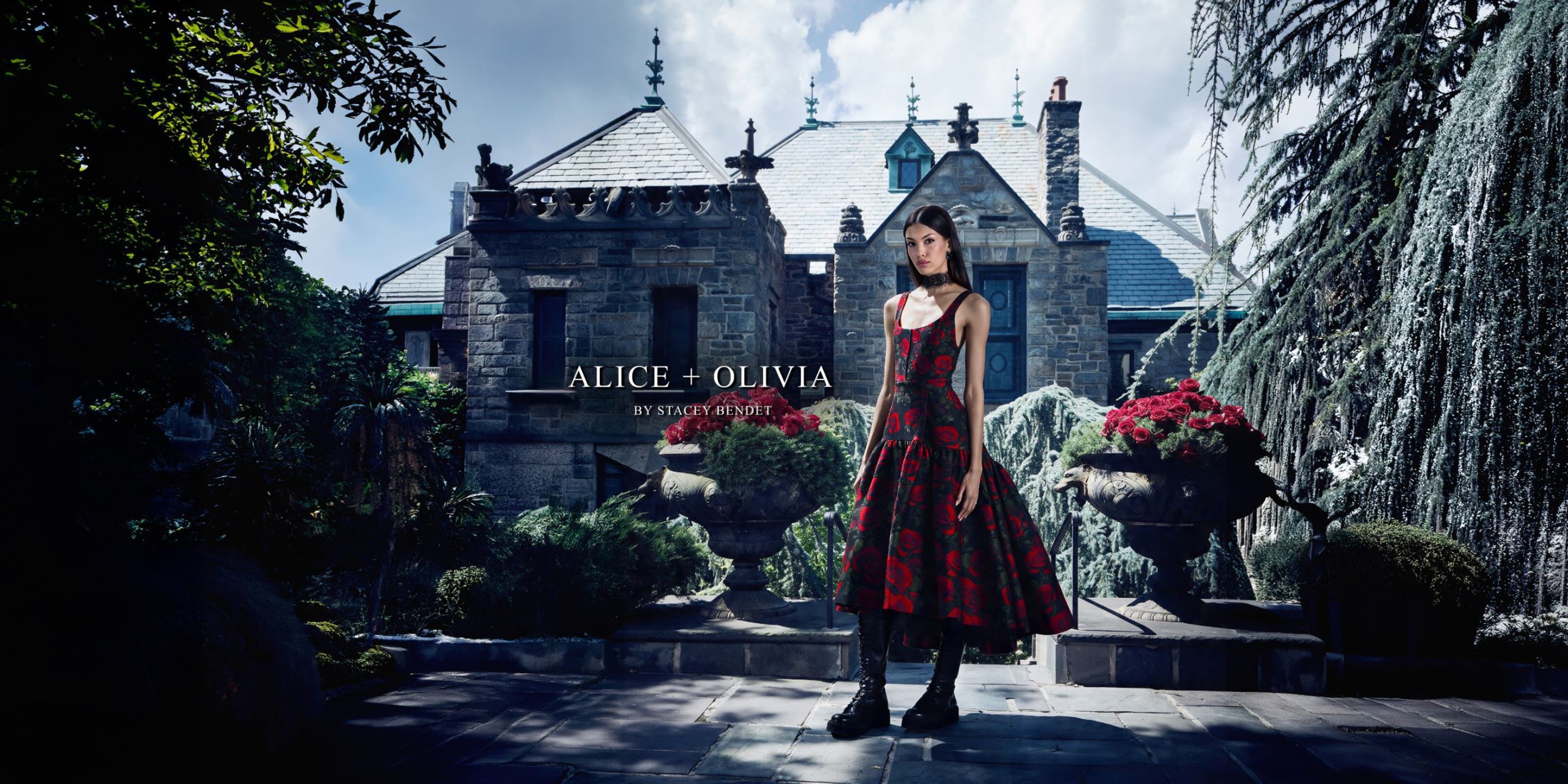 Woman in a black and red floral dress and boots from ALICE + OLIVIA.