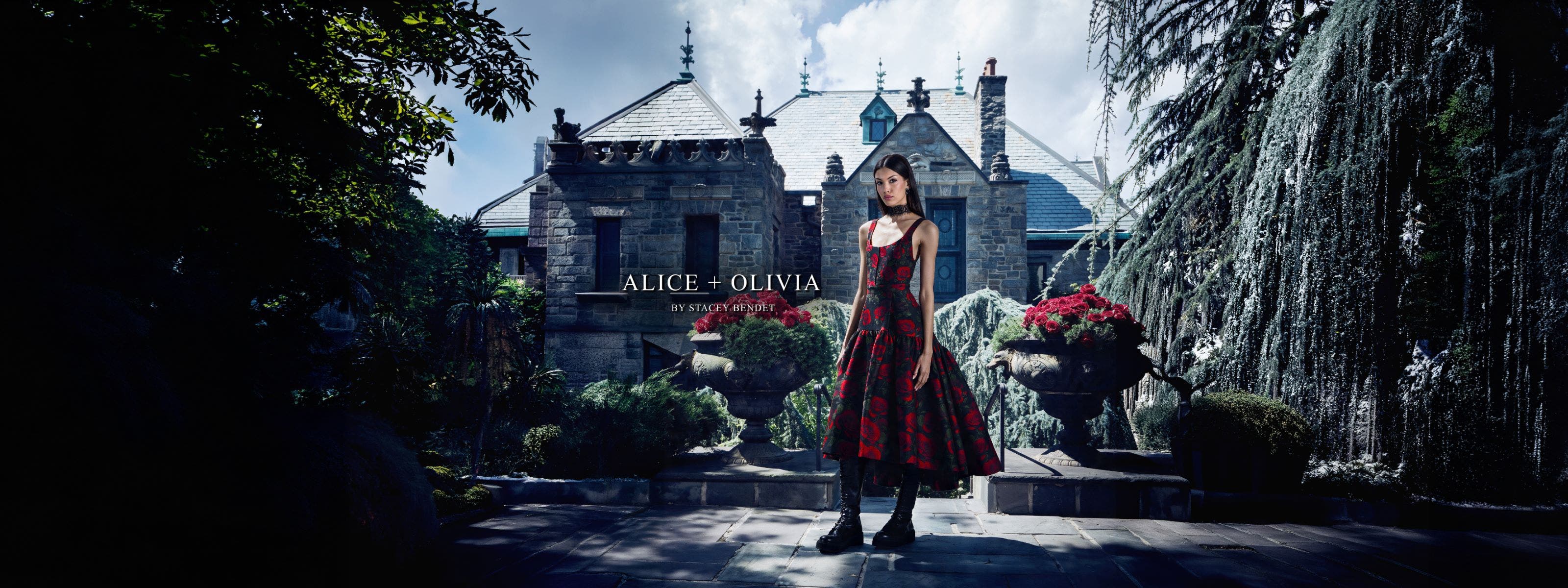 Woman in a black and red floral dress and boots from ALICE + OLIVIA.